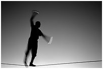 Equilibrist on Mallory Square, sunset. Key West, Florida, USA ( black and white)