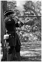 Man in period costume fires smooth bore musket, Fort Matanzas National Monument. St Augustine, Florida, USA (black and white)