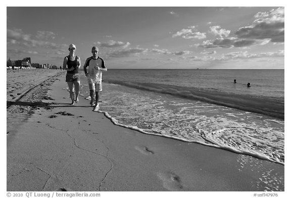 Couple jogging on beach,  Miami Beach. Florida, USA (black and white)