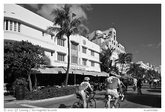 Cyclists passing Art Deco hotels, Miami Beach. Florida, USA