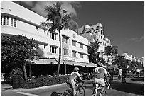 Cyclists passing Art Deco hotels, Miami Beach. Florida, USA (black and white)