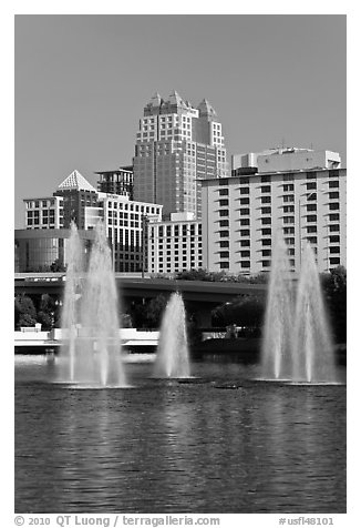 Fountains and downtown high-rises from Lake Lucerne. Orlando, Florida, USA