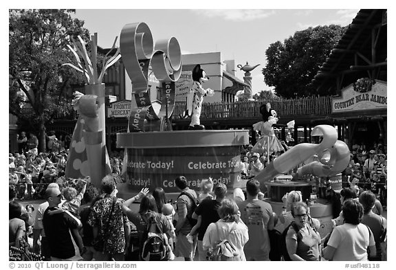 Crowds attends parade with Mickey and Minnie characters. Orlando, Florida, USA