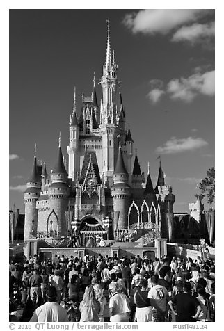 Tourists attend stage musical in front of Cindarella castle. Orlando, Florida, USA (black and white)