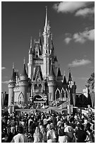 Tourists attend stage musical in front of Cindarella castle. Orlando, Florida, USA (black and white)