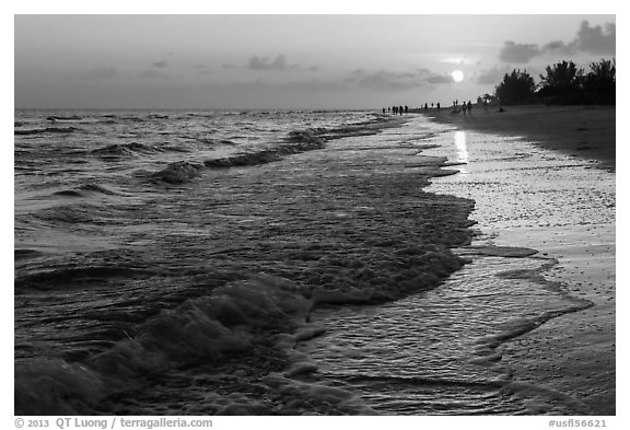 Beach with people in the distance at sunset, Sanibel Island. Florida, USA