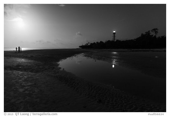 Lighthouse beach with family in distance and moonlight, Sanibel Island. Florida, USA