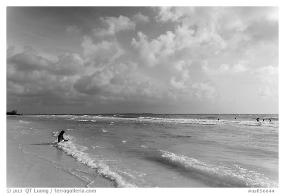 Woman sitting in water, Fort De Soto beach. Florida, USA