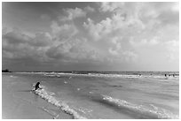 Woman sitting in water, Fort De Soto beach. Florida, USA (black and white)