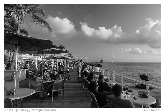 Waiting for sunset with drink in hand on Mallory Square. Key West, Florida, USA (black and white)