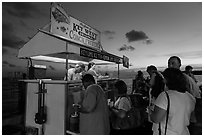 People buying food at stand on Mallory Square. Key West, Florida, USA (black and white)