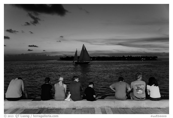 Tourists watching ocean after sunset, Mallory Square. Key West, Florida, USA (black and white)