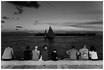 Tourists watching ocean after sunset, Mallory Square. Key West, Florida, USA ( black and white)