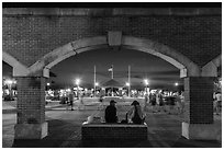 Mallory Square at dust seen through arches. Key West, Florida, USA (black and white)