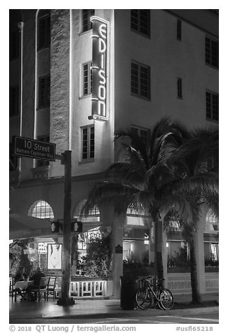 Corner street with Edison hotel, bicycle and palm tree at night, Miami Beach. Florida, USA (black and white)