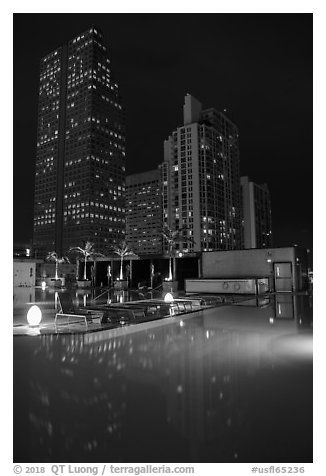 Pool surrouned by high rise towers at night, Miami. Florida, USA (black and white)