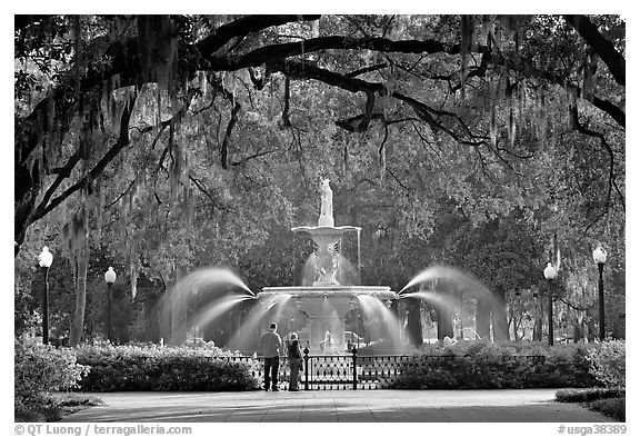 Fountain in Forsyth Park with couple standing. Savannah, Georgia, USA (black and white)