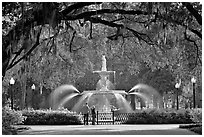 Fountain in Forsyth Park with couple standing. Savannah, Georgia, USA (black and white)