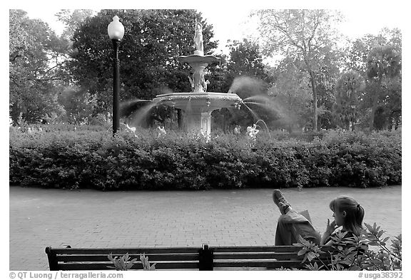 Woman reading in front of Forsyth Park Fountain. Savannah, Georgia, USA