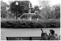 Woman reading in front of Forsyth Park Fountain. Savannah, Georgia, USA ( black and white)