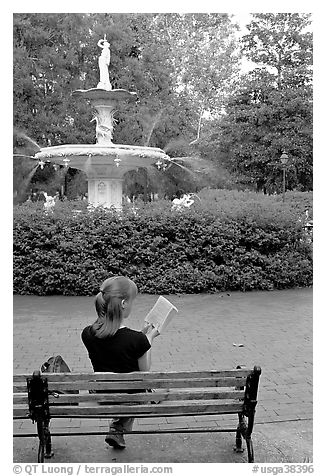 Woman reading a book in front of Forsyth Park Fountain. Savannah, Georgia, USA (black and white)