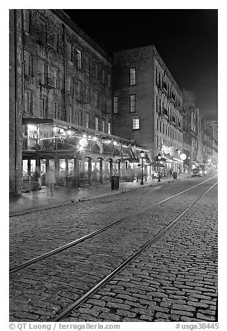 Brick and cobblestone waterside street by night. Savannah, Georgia, USA (black and white)