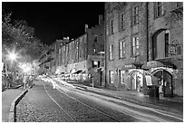 Car lights on River Street by night. Savannah, Georgia, USA ( black and white)