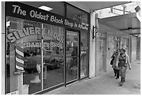 Women walking in front of oldest black shop in Atlanta. Atlanta, Georgia, USA (black and white)