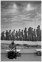 African American man sitting in front of march mural inside Martin Luther King, Jr. Visitor Center. Atlanta, Georgia, USA ( black and white)