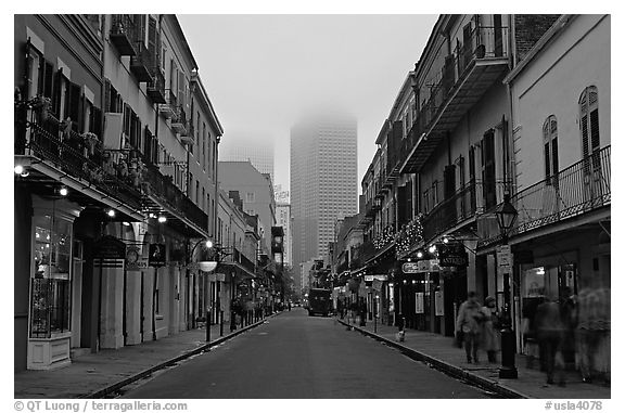 Bourbon street and the new town in the fog, French Quarter. New Orleans, Louisiana, USA (black and white)