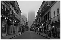 Bourbon street and the new town in the fog, French Quarter. New Orleans, Louisiana, USA (black and white)