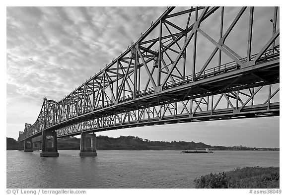 Barge on the Mississippi River approaching bridges. Natchez, Mississippi, USA (black and white)