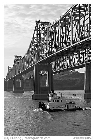 Tugboat under brige on Mississippi River. Natchez, Mississippi, USA (black and white)