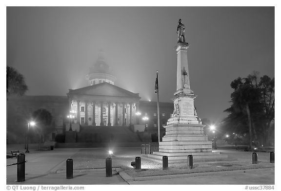 Monument to Confederate soldiers and state capitol at night. Columbia, South Carolina, USA