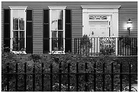 House facade at dusk with roses in front yard. Charleston, South Carolina, USA (black and white)