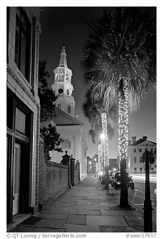 St Michael Episcopal Church, sidewalk, and palm trees at night. Charleston, South Carolina, USA