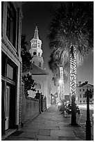 St Michael Episcopal Church, sidewalk, and palm trees at night. Charleston, South Carolina, USA (black and white)