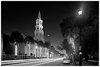 St Michael Episcopal Church and street with traffic at night. Charleston, South Carolina, USA (black and white)