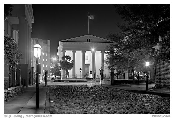 Street with cobblestone pavement at night. Charleston, South Carolina, USA (black and white)
