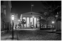 Street with cobblestone pavement at night. Charleston, South Carolina, USA (black and white)