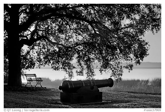 Cannon, and bench overlooking Beaufort Bay at sunrise. Beaufort, South Carolina, USA