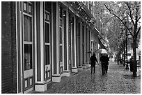 People with unbrellas on 2nd street sidewalk. Nashville, Tennessee, USA ( black and white)