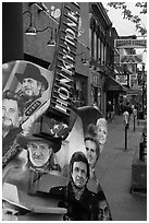 Guitar-shaped sign with images of famous singers on Broadway sidewalk. Nashville, Tennessee, USA (black and white)