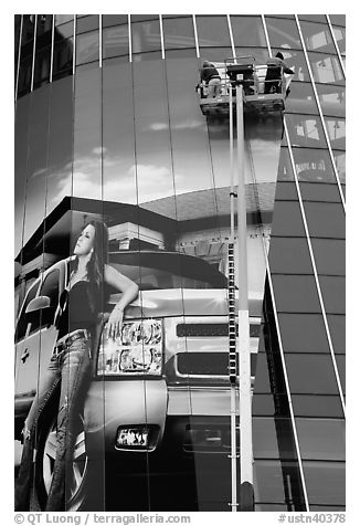 Workers pasting mural-sized car advertising on building. Nashville, Tennessee, USA (black and white)