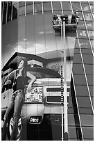 Workers pasting mural-sized car advertising on building. Nashville, Tennessee, USA ( black and white)