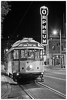 Trolley and Orpheum theater sign by night. Memphis, Tennessee, USA (black and white)