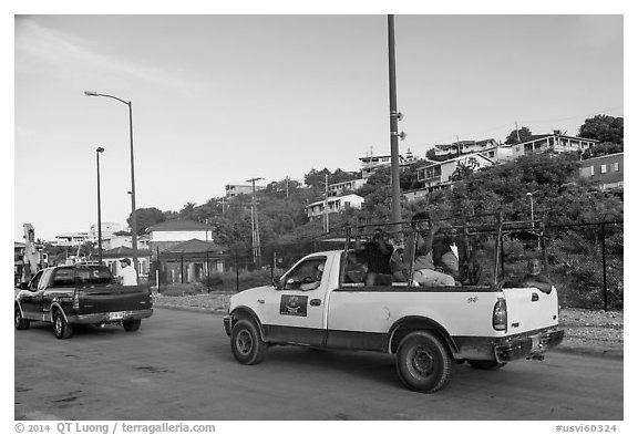 Residents riding in back of pick-up trucks, Cruz Bay. Saint John, US Virgin Islands (black and white)