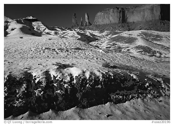 Snow on the floor, with Three Sisters in the background. Monument Valley Tribal Park, Navajo Nation, Arizona and Utah, USA (black and white)