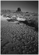 Clay pattern on floor and buttes in winter. Monument Valley Tribal Park, Navajo Nation, Arizona and Utah, USA (black and white)