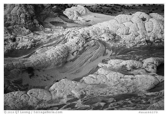 White crossbedded sandstone layer capping twirls of red sandstone. Vermilion Cliffs National Monument, Arizona, USA (black and white)